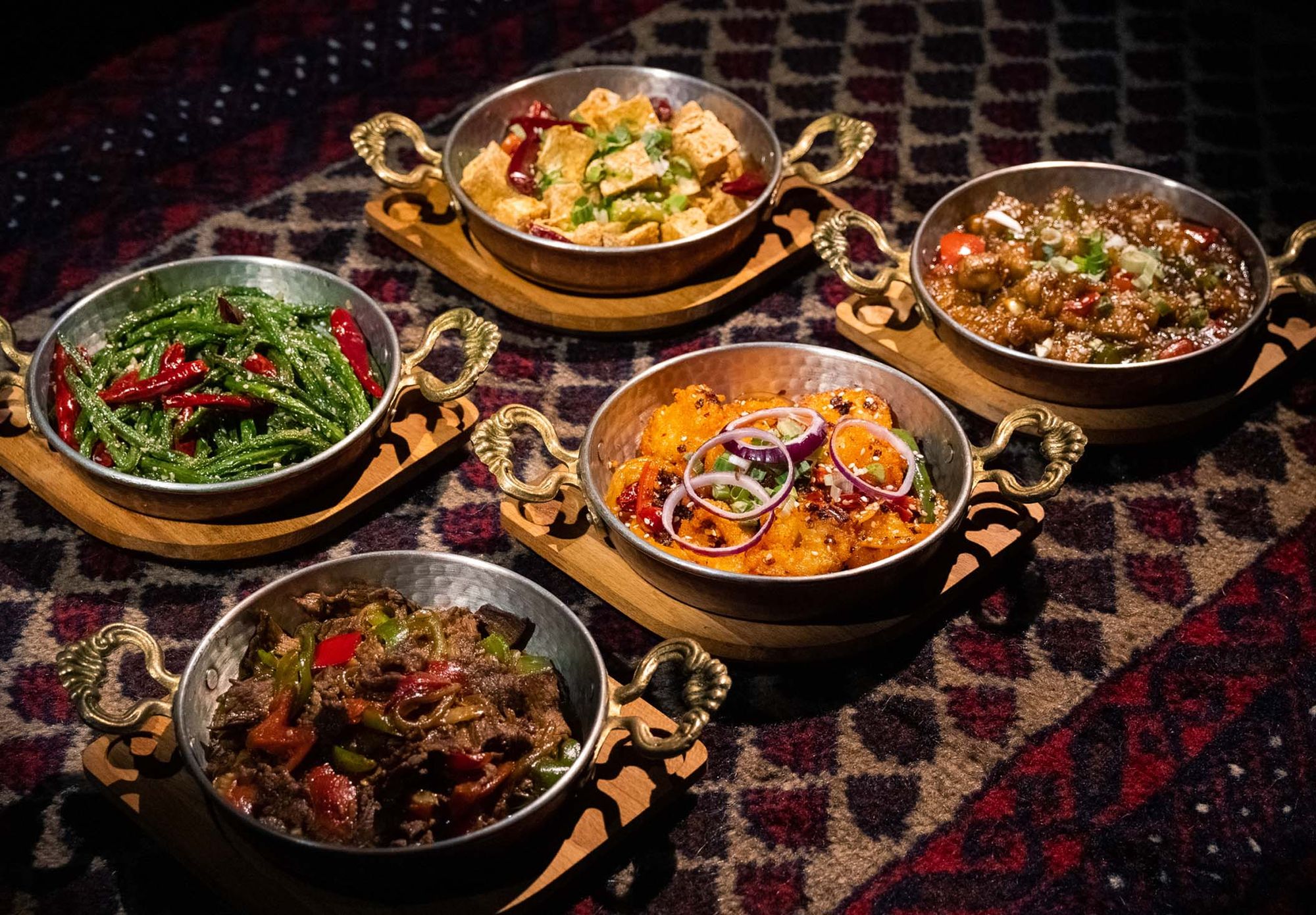 A spread of Uyghur dishes laid out for a group celebration