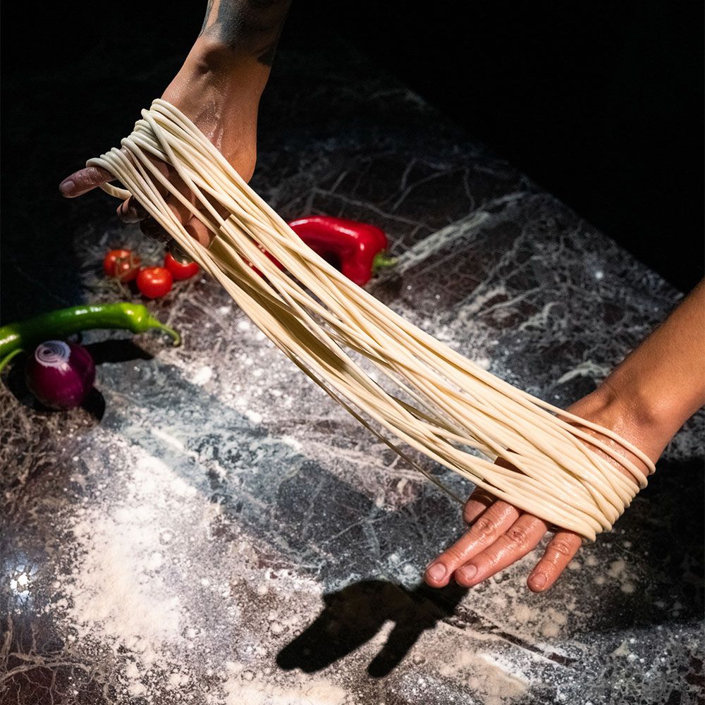 Stretching hand-pulled noodle dough